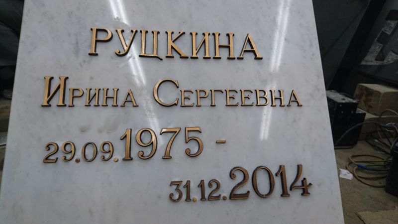 Накладные бронзовые буквы на мраморном памятнике.